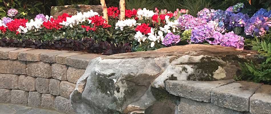 This custom seating wall and softscape in Hendersonville is a perfect spot for a serenity garden.