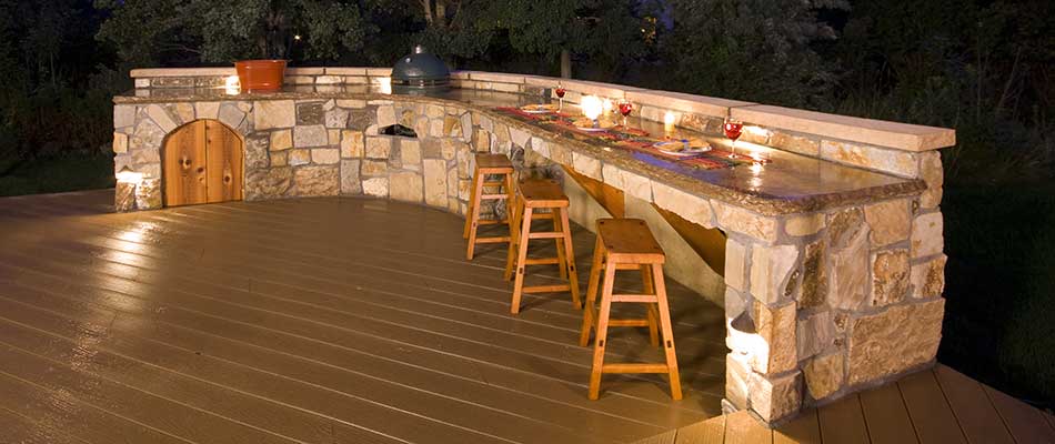 Outdoor kitchen with a bar and seating in Hendersonville, TN.